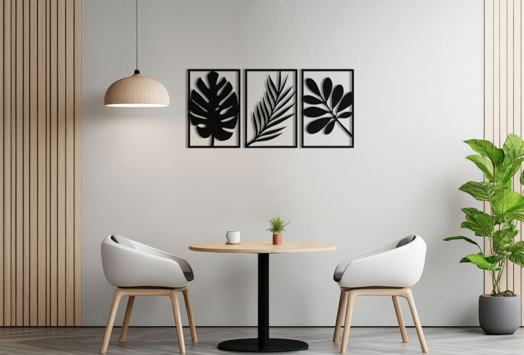 A white and orange framed picture hangs on a wall in a room with a table and two chairs