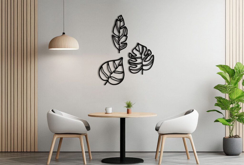 A white and orange framed picture hangs on a wall in a room with a table and two chairs